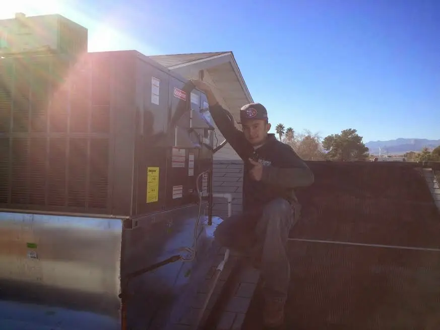 HVAC technician performing AC Tune-Up on a rooftop unit in Croton-on-Hudson